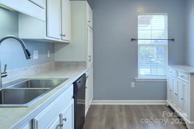 a view white cabinets and a sink