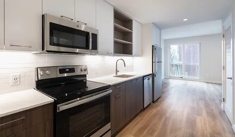 a kitchen with a sink stove and microwave