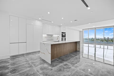 a view of kitchen with stainless steel appliances granite countertop a stove a sink and a refrigerator