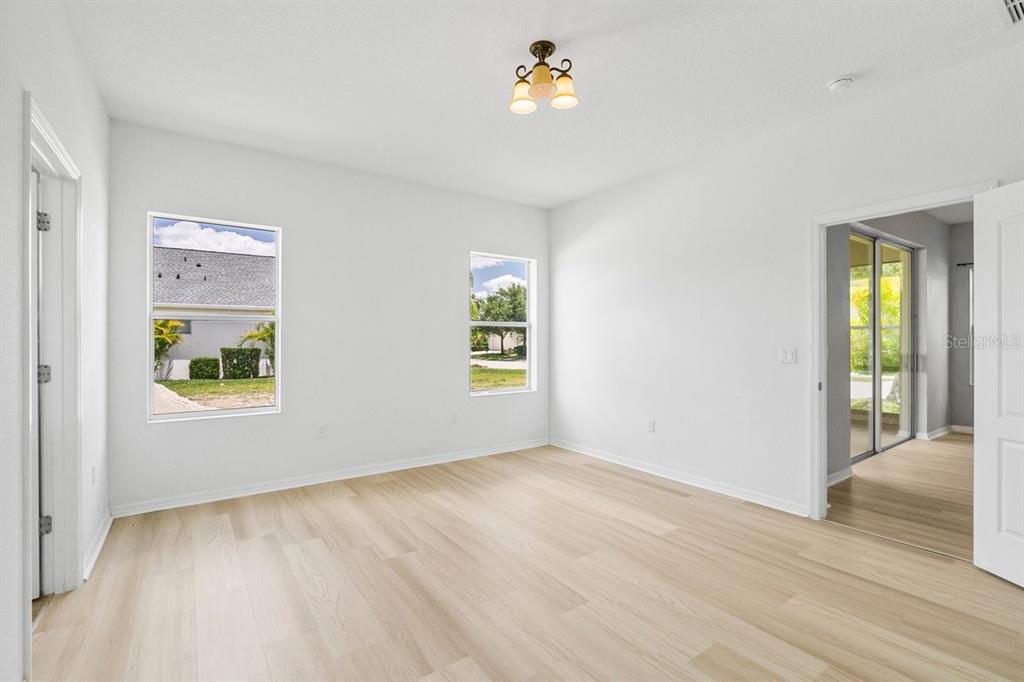 11790 Fennemore Way Parrish, FL 34219 - Photo 11 of 25 wooden floor in an empty room with a window