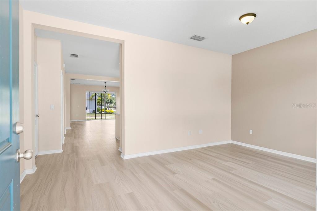11790 Fennemore Way Parrish, FL 34219 - Photo 3 of 25 wooden floor in a hall with an empty room
