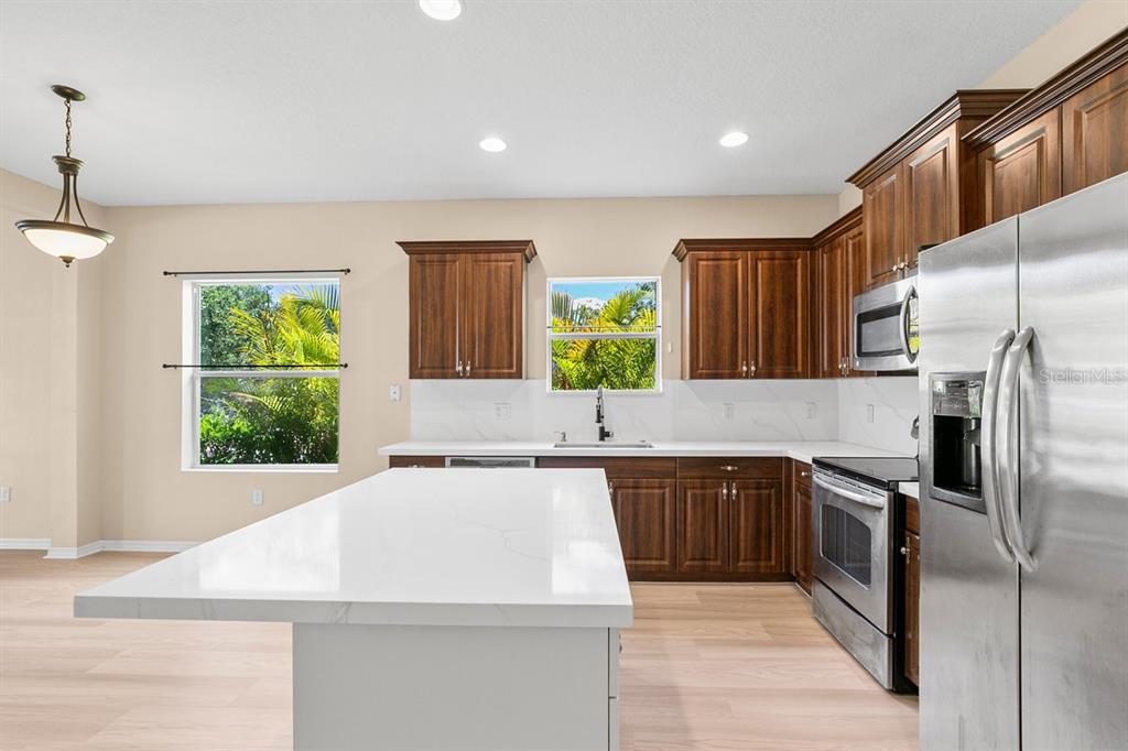 11790 Fennemore Way Parrish, FL 34219 - Photo 7 of 25 a kitchen with a sink stove and refrigerator
