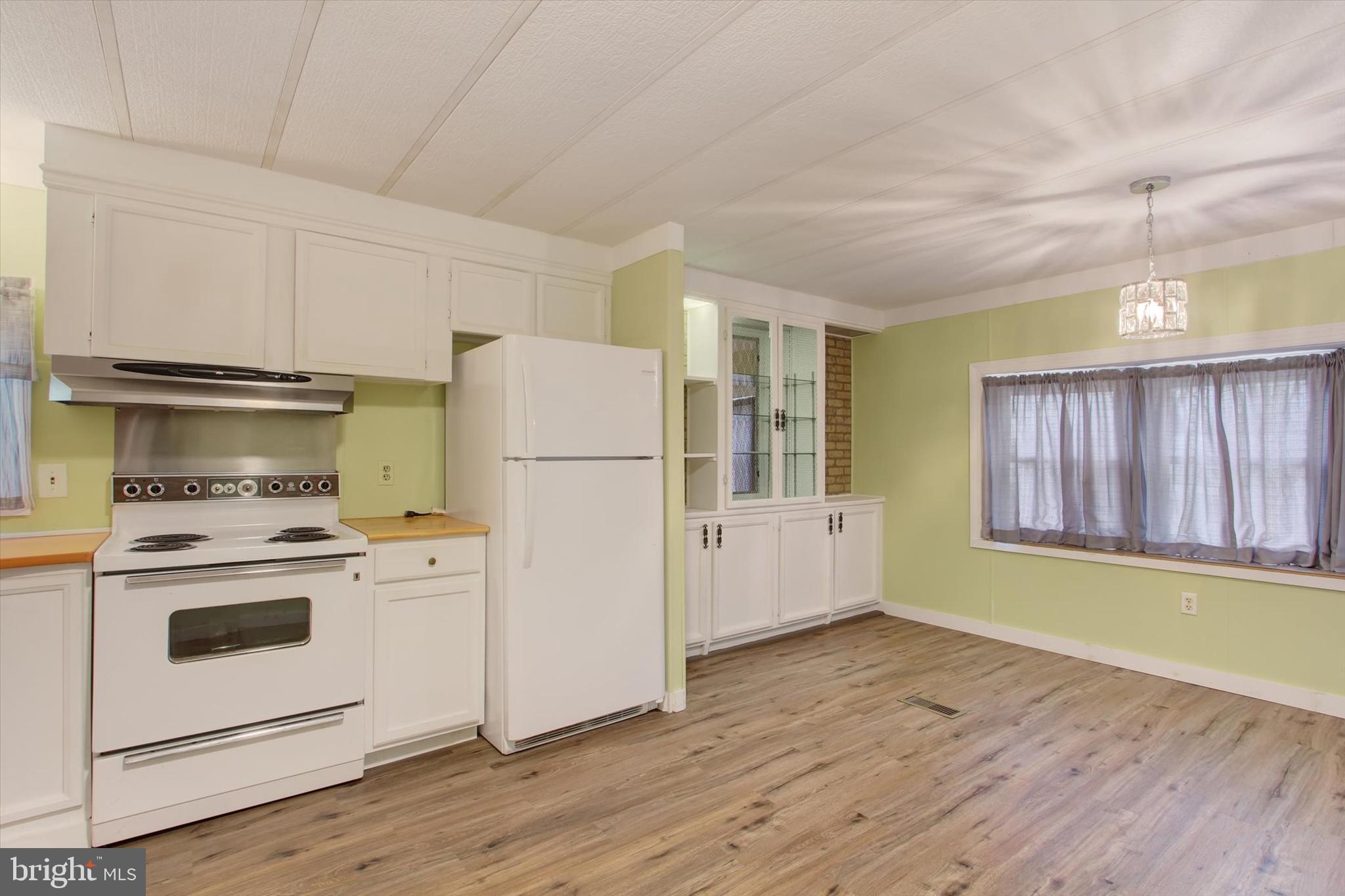 3631 Fairfield Road, Unit (8 837 ACRES) Gettysburg, PA 17325 - Photo 16 of 24 a kitchen with a refrigerator a stove top oven a sink and dishwasher with wooden floor