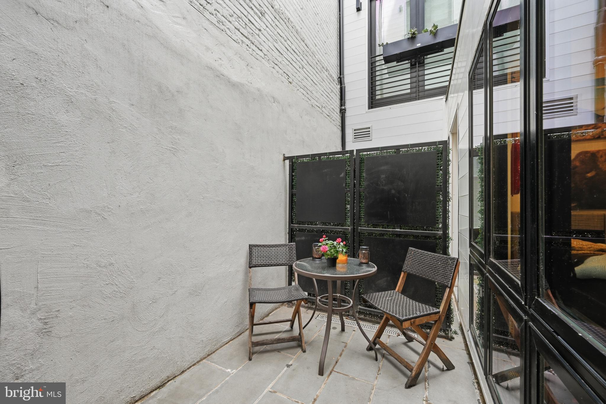 1402 12th Street Northwest, Unit 3 Washington, DC 20005 - Photo 21 of 23 a patio with table and chairs and potted plants