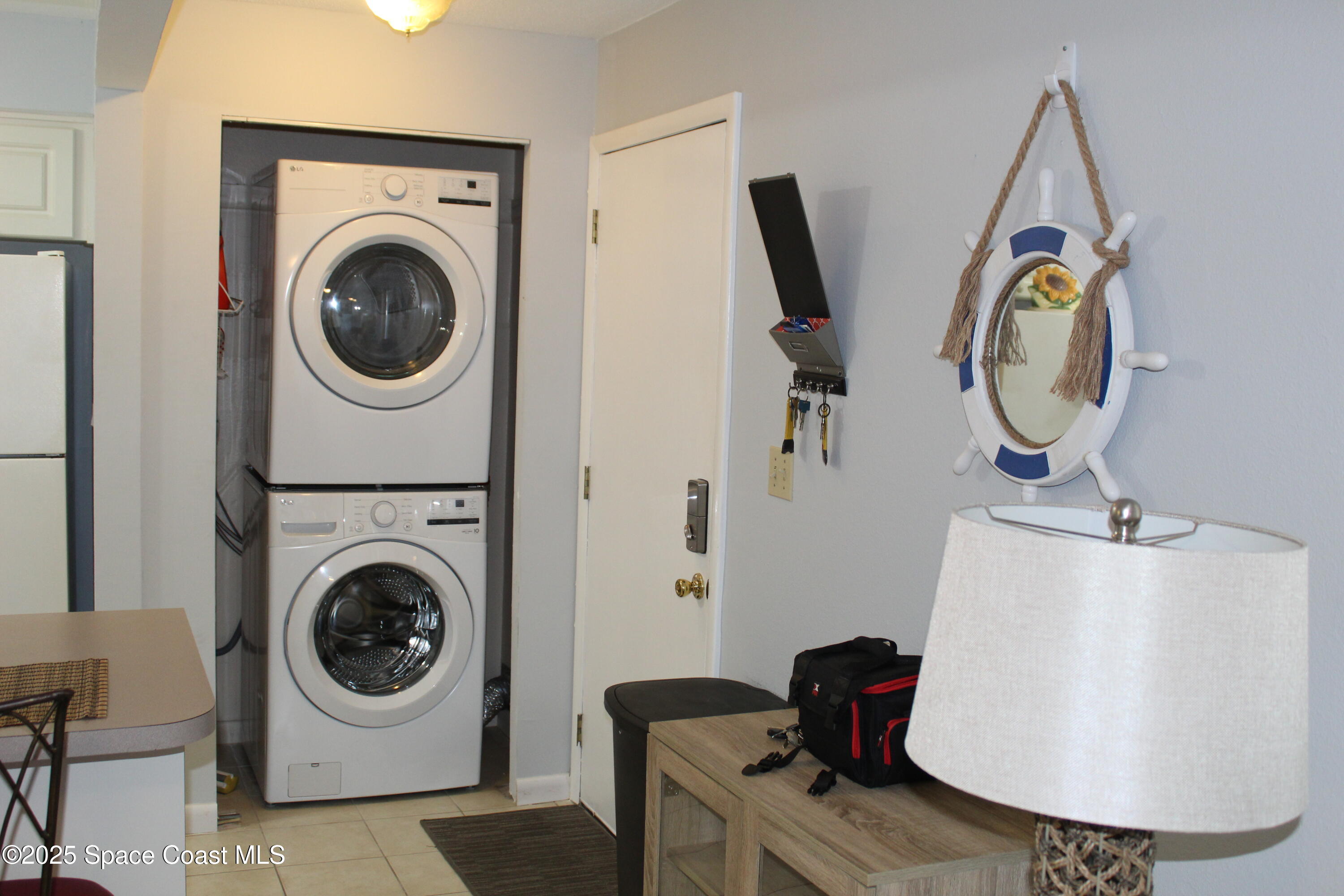 3150 North Atlantic Avenue, Unit 14880 Cocoa Beach, FL 32931 - Photo 3 of 13 a utility room with dryer and washer