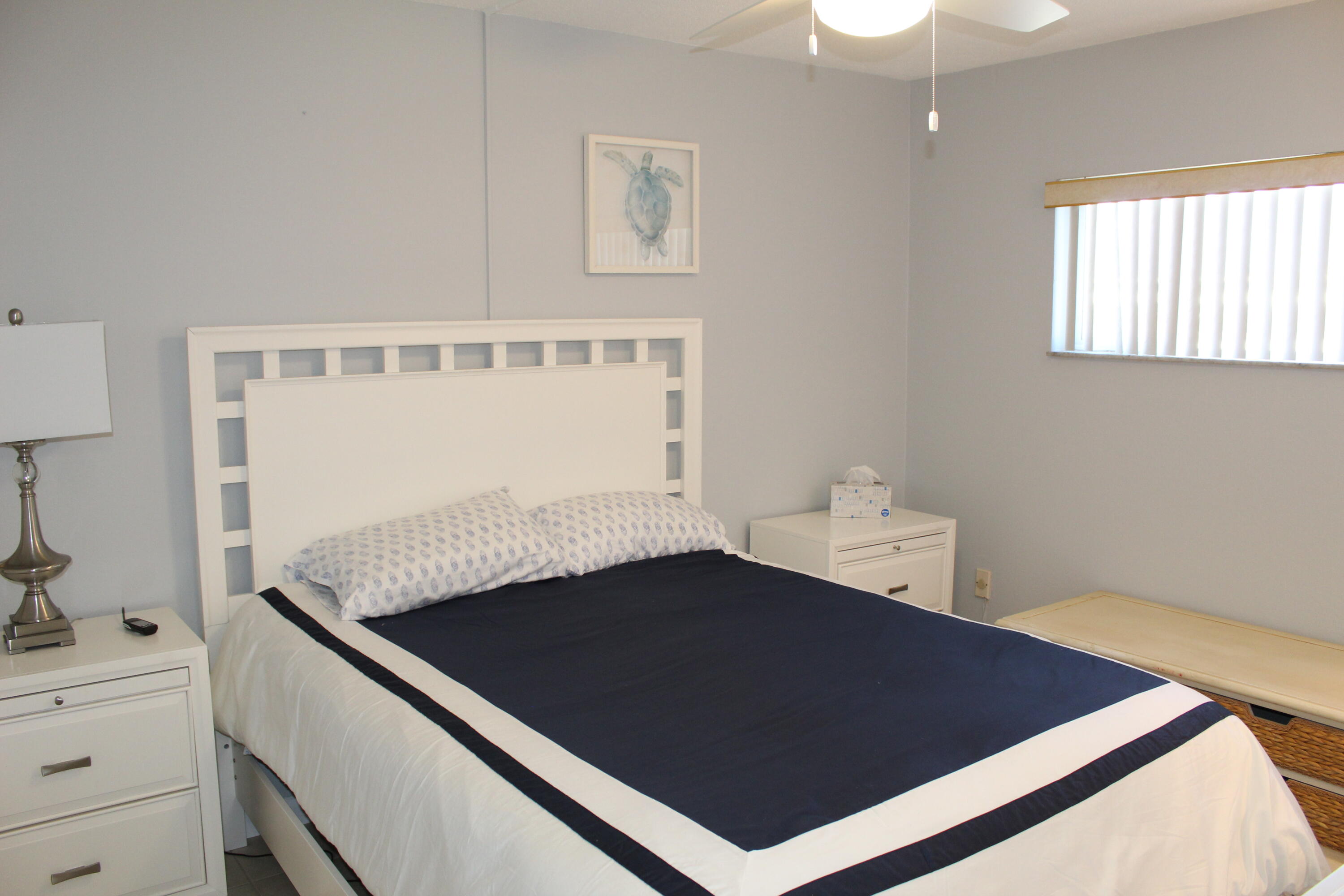 3150 North Atlantic Avenue, Unit 14880 Cocoa Beach, FL 32931 - Photo 8 of 13 a living room with a bed furniture and a window