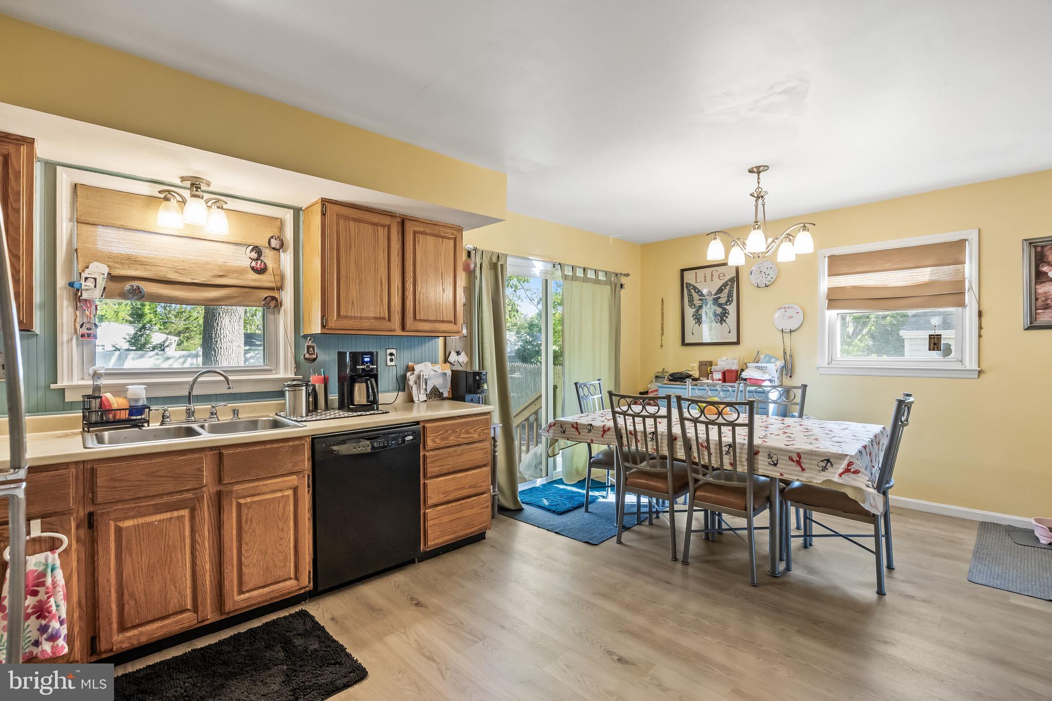 109 North Ambler Road Somers Point, NJ 08244 - Photo 14 of 22 a kitchen with sink cabinets and dining table