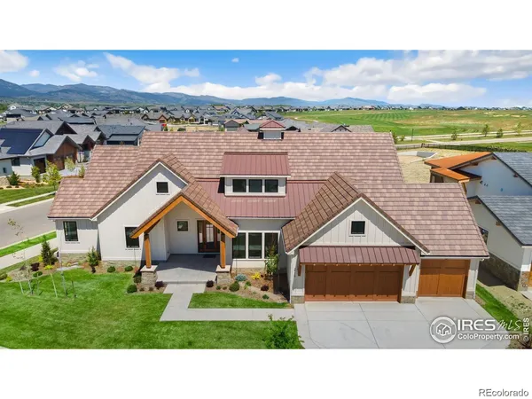 a aerial view of a house with a yard and balcony