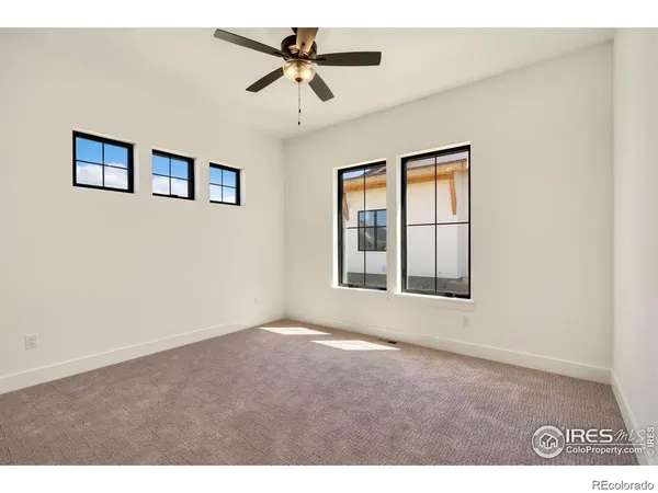 a view of a livingroom with wooden floor and window
