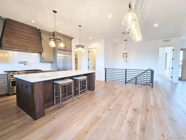 a large room with wooden floor and large windows