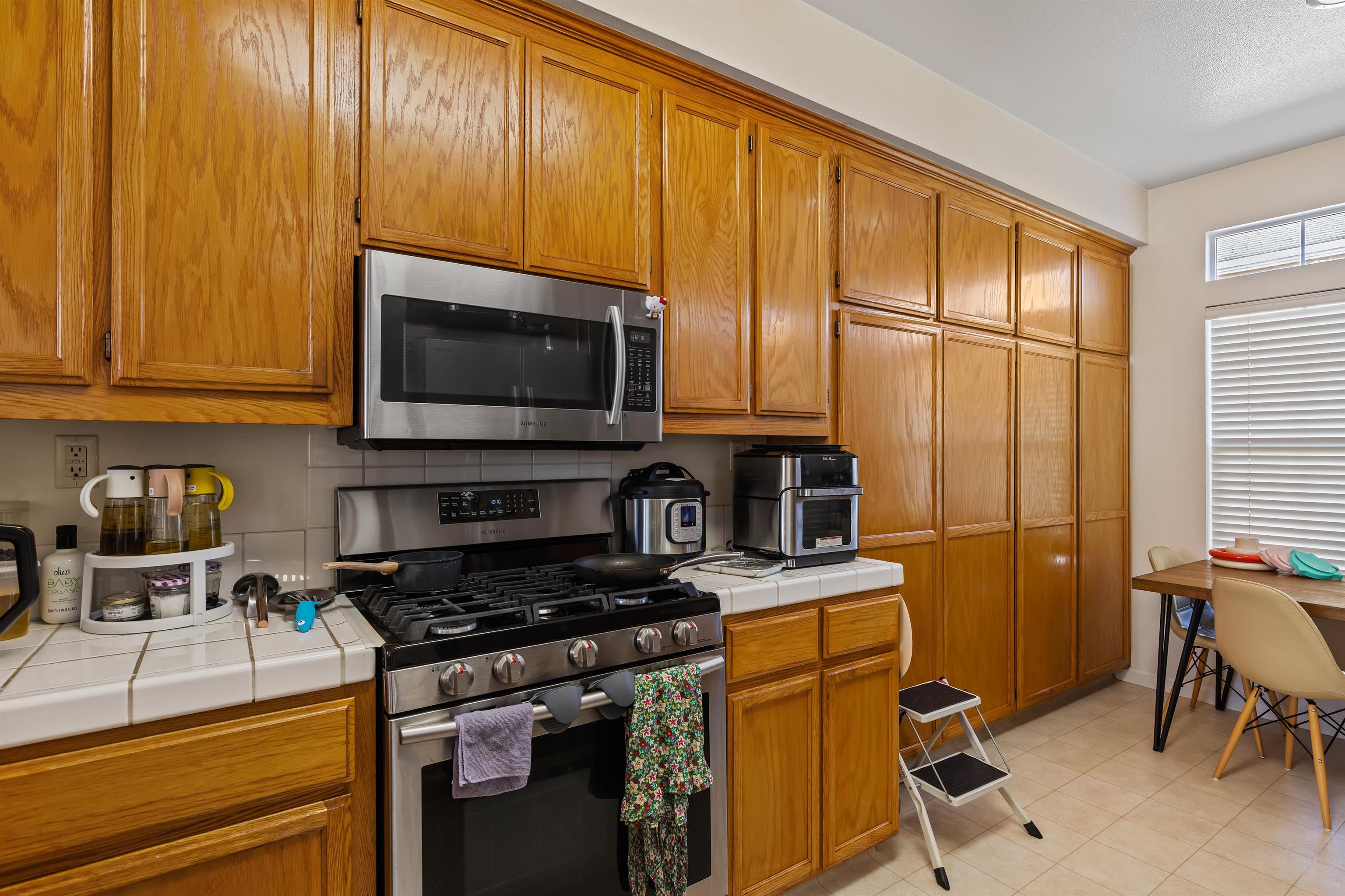 3567 Dayton Common Fremont, CA 94538 - Photo 11 of 29 a kitchen with stainless steel appliances a stove a sink and a microwave
