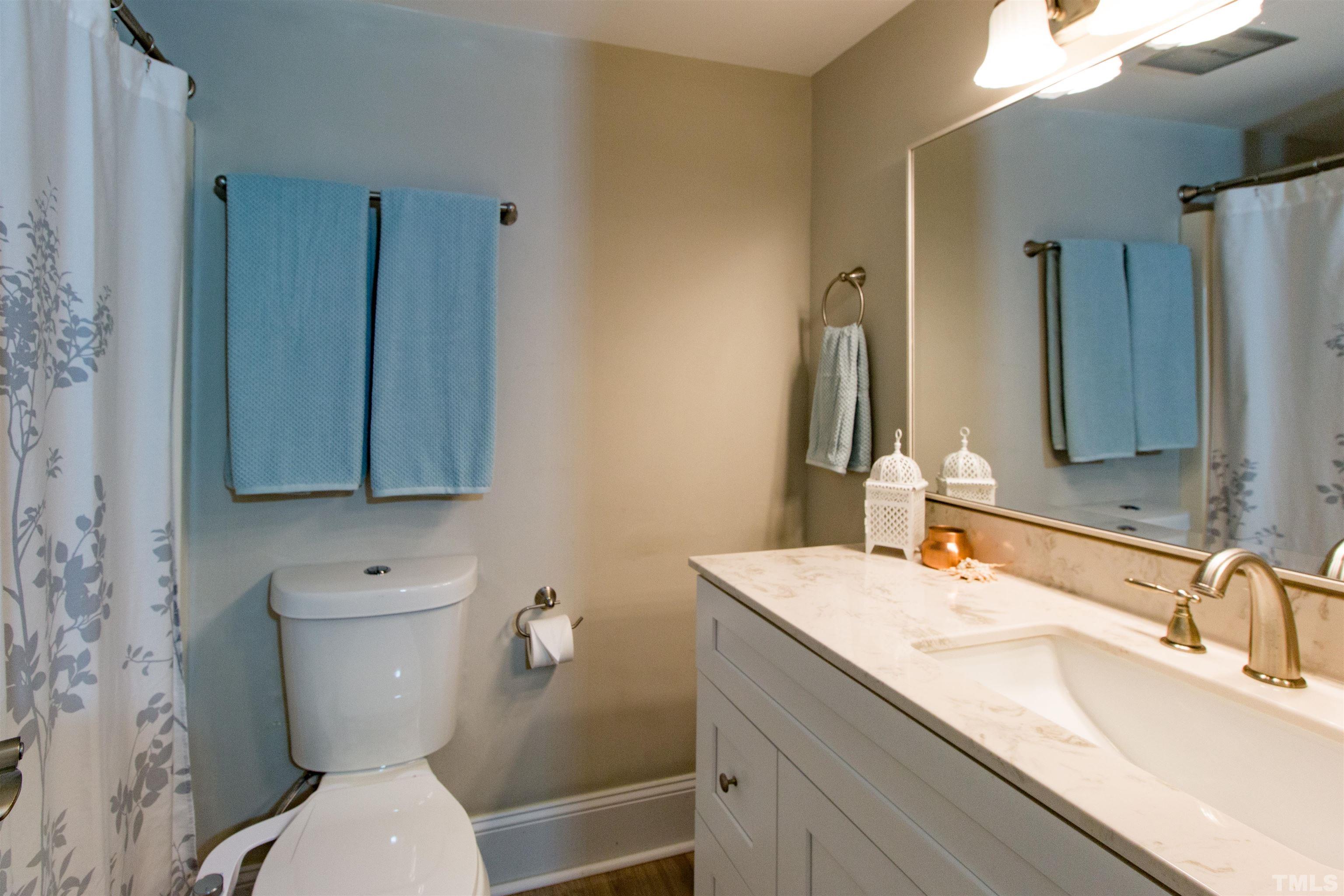 4711 Edwards Mill Road, Unit C Raleigh, NC 27612 - Photo 7 of 13 a bathroom with a toilet sink and mirror