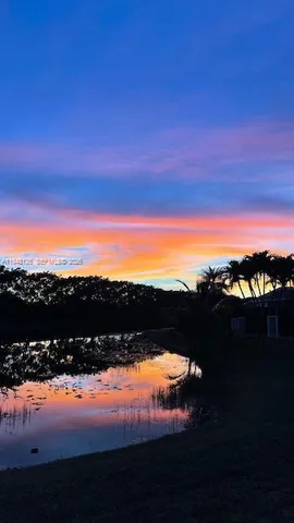 a bedroom with a bed and a large mirror