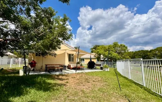 a view of a house with backyard porch and sitting area