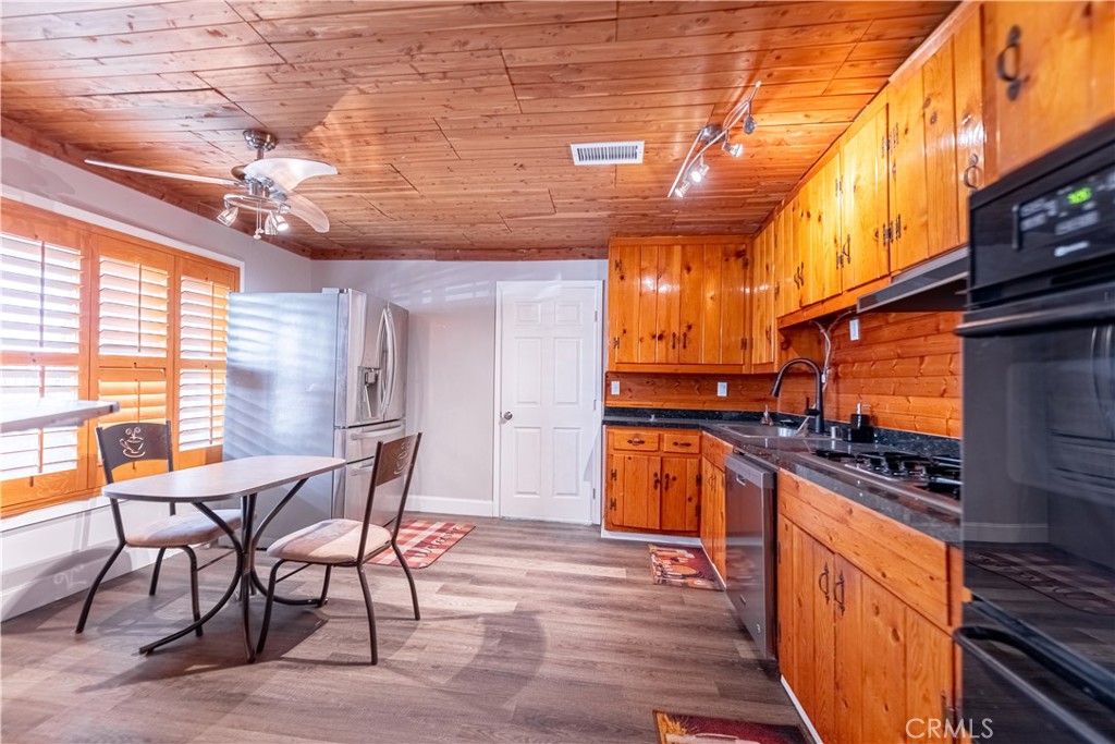 4759 Cochran Street Simi Valley, CA 93063 - Photo 11 of 71 a kitchen with stainless steel appliances granite countertop a table chairs and a stove