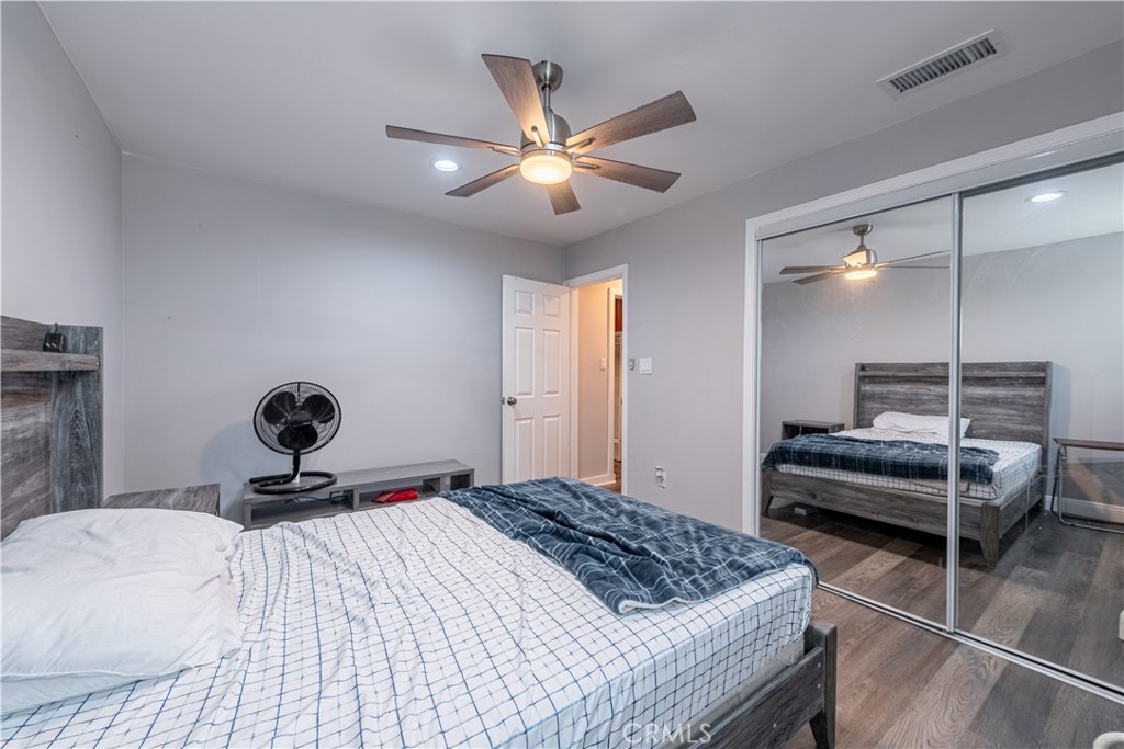 4759 Cochran Street Simi Valley, CA 93063 - Photo 15 of 71 a bedroom with a bed and a chandelier