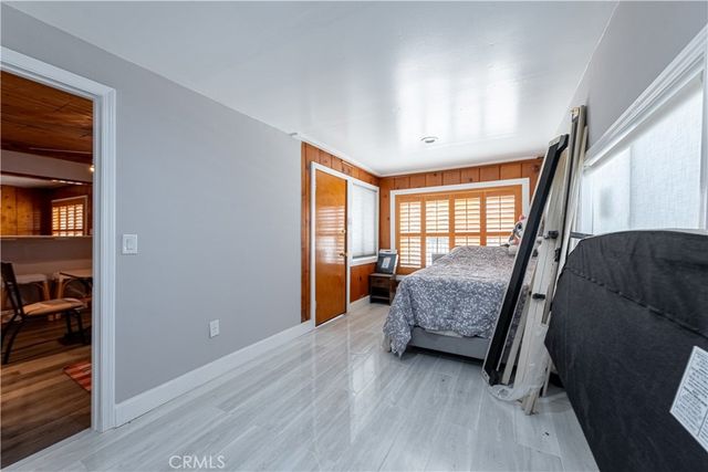 a bed room with a bed and a wooden floor