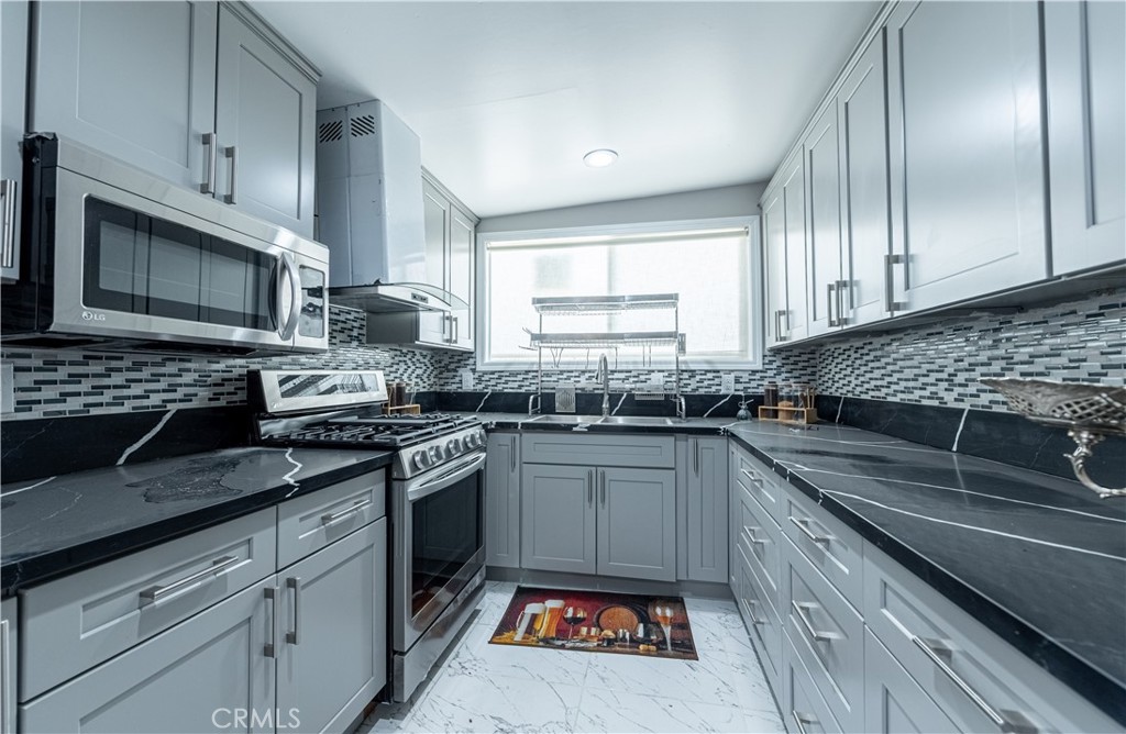 4759 Cochran Street Simi Valley, CA 93063 - Photo 24 of 71 a kitchen with stainless steel appliances granite countertop a sink stove and cabinets