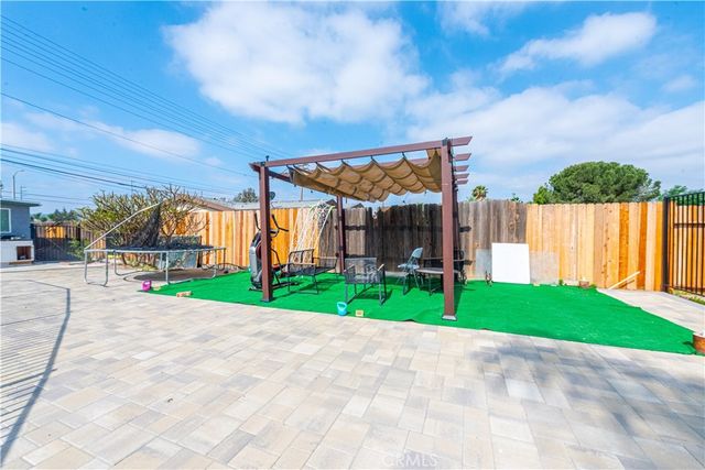 a backyard of a house with table and chairs