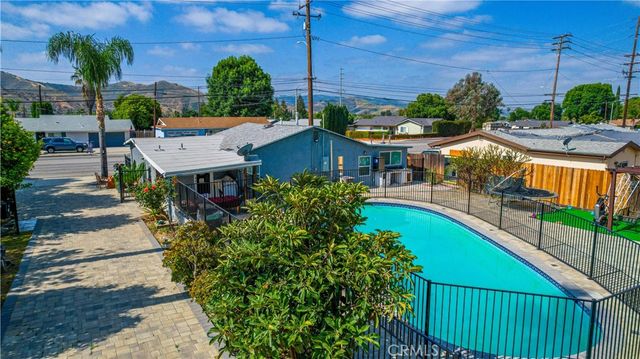 a backyard of a house with garden and barbeque oven