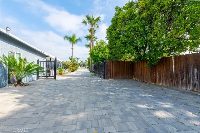 a view of a house with a yard and potted plants