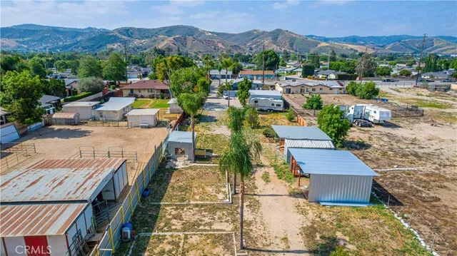 a living room with furniture ceiling fan and a large window