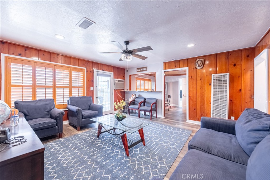 4759 Cochran Street Simi Valley, CA 93063 - Photo 9 of 71 a living room with furniture ceiling fan and a large window