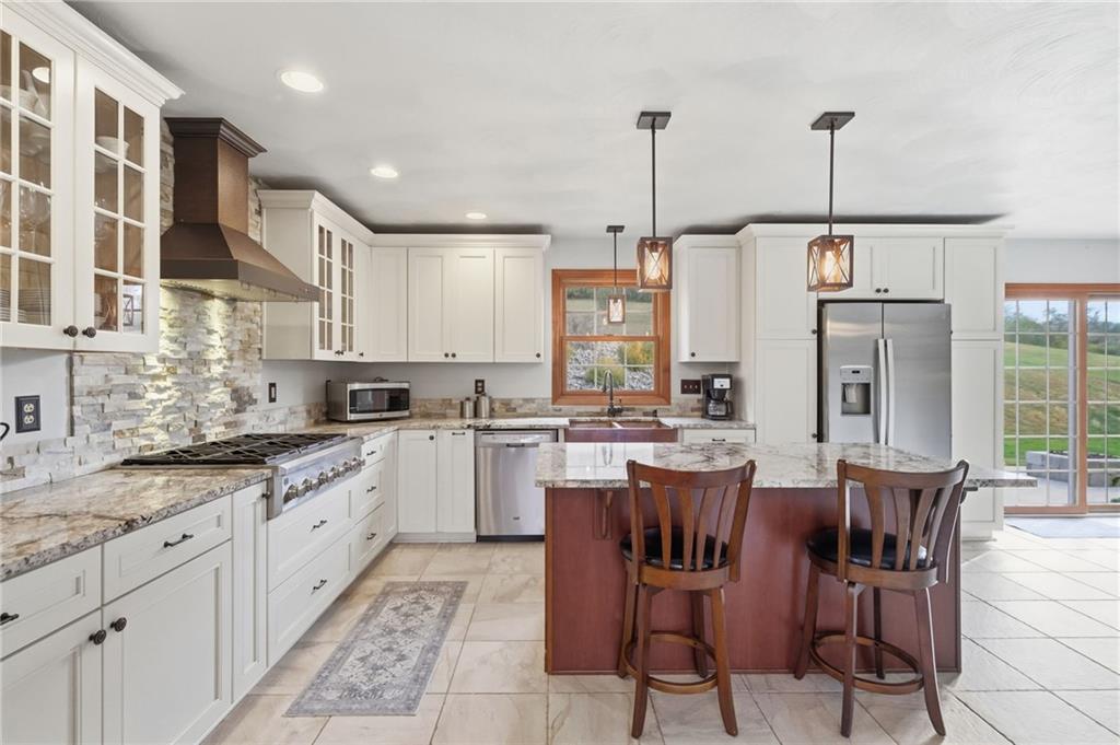 1146 Sarver Road Sarver, PA 16055 - Photo 14 of 50 a kitchen with stainless steel appliances granite countertop sink refrigerator and cabinets