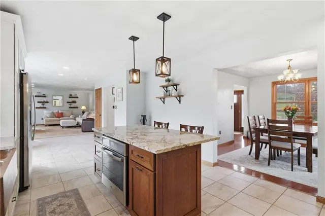 a room with furniture a clock and a view of living room