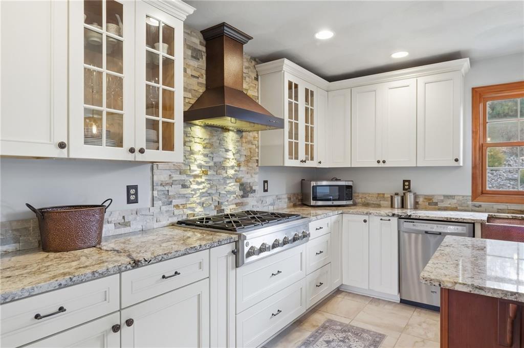 1146 Sarver Road Sarver, PA 16055 - Photo 18 of 50 a kitchen with stainless steel appliances granite countertop a stove a sink and white cabinets