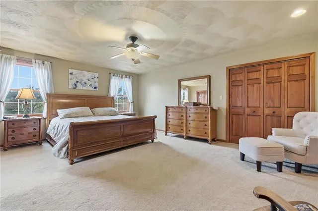 a bedroom with a bed a couch and dresser