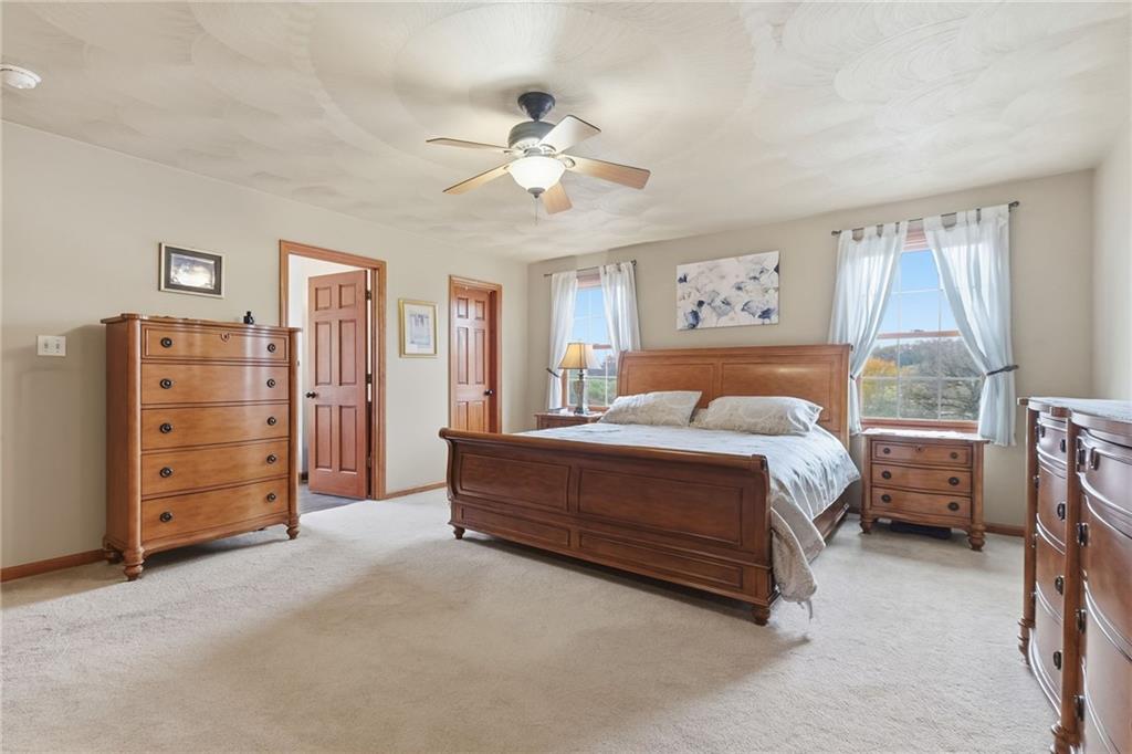 1146 Sarver Road Sarver, PA 16055 - Photo 27 of 50 a spacious bedroom with a bed and a chandelier