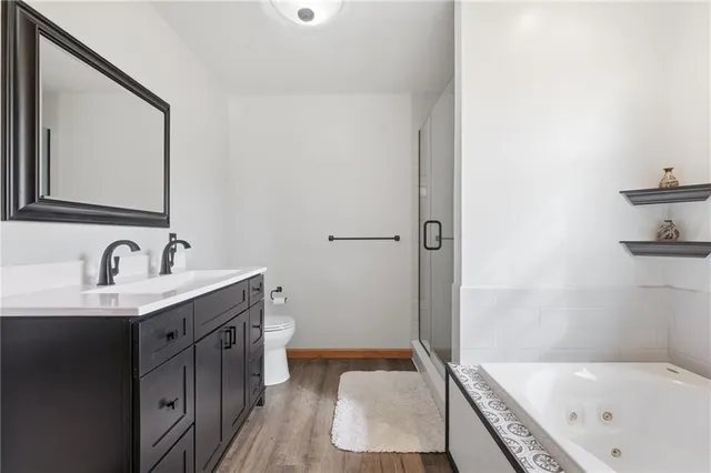 a bathroom with a tub sink and mirror