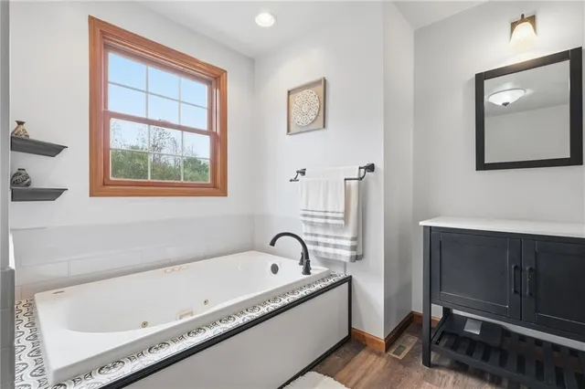 a bathroom with a bathtub and a window