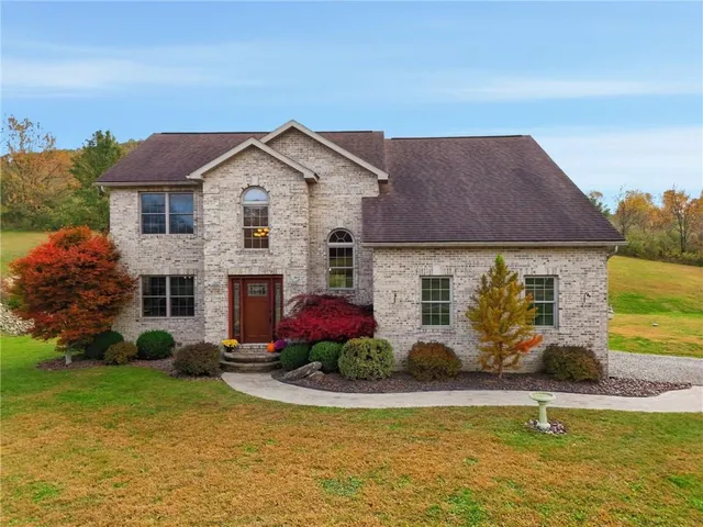 a front view of house with yard and swimming pool