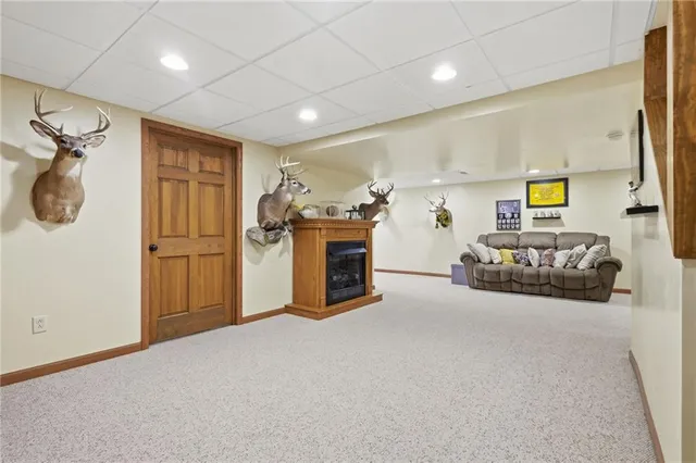 a view of a livingroom with furniture and a refrigerator