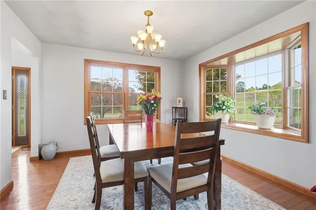 a view of a dining room with furniture wooden floor and a chandelier