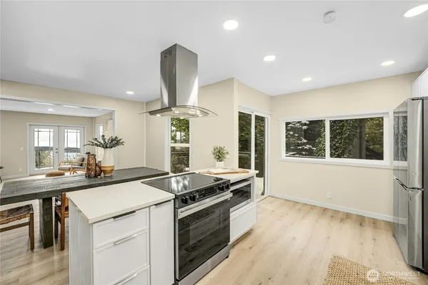 a kitchen with stainless steel appliances granite countertop a sink stove and cabinets