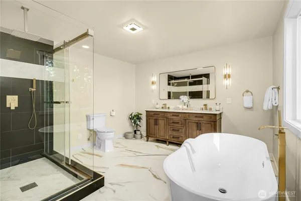 a spacious bathroom with a tub a sink and mirror