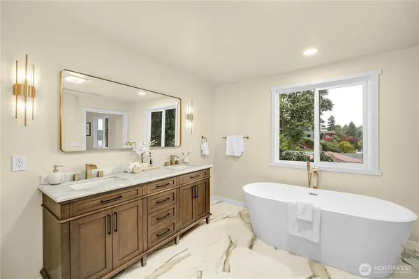a bathroom with a double vanity sink tub and mirror