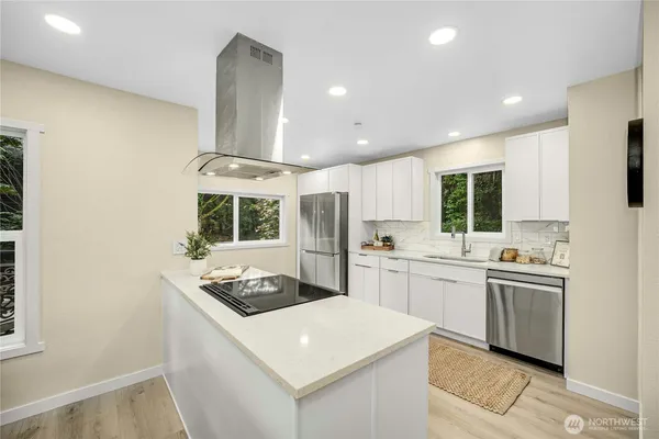 a kitchen with stainless steel appliances granite countertop a sink stove and refrigerator