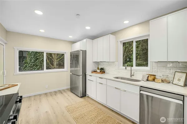 a kitchen with a sink window and cabinets