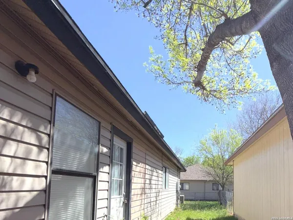 a view of a house with a backyard