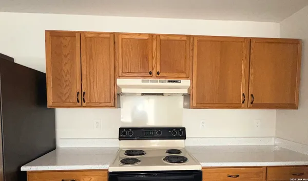 a kitchen with stainless steel appliances wooden cabinets and a stove top oven