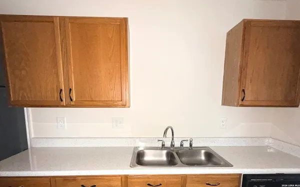a kitchen with a sink and cabinets