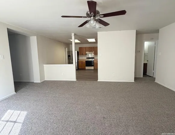 a view of a big room with closet and ceiling fan
