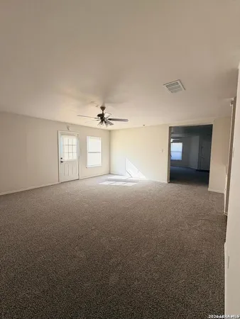 a view of empty room with window and fireplace