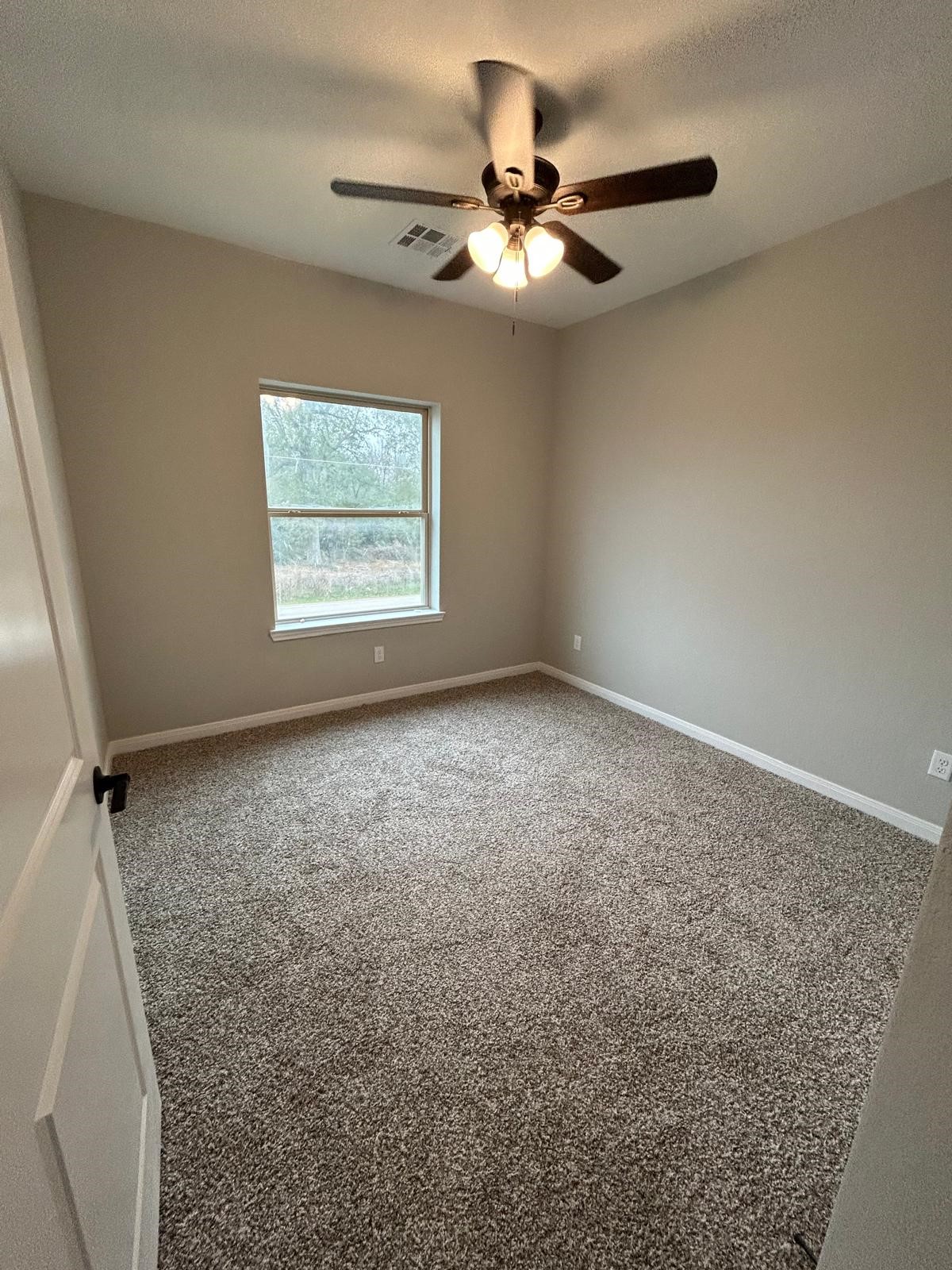 14010 Longstreet Road, Unit 14 Willis, TX 77318 - Photo 12 of 18 an empty room with a window
