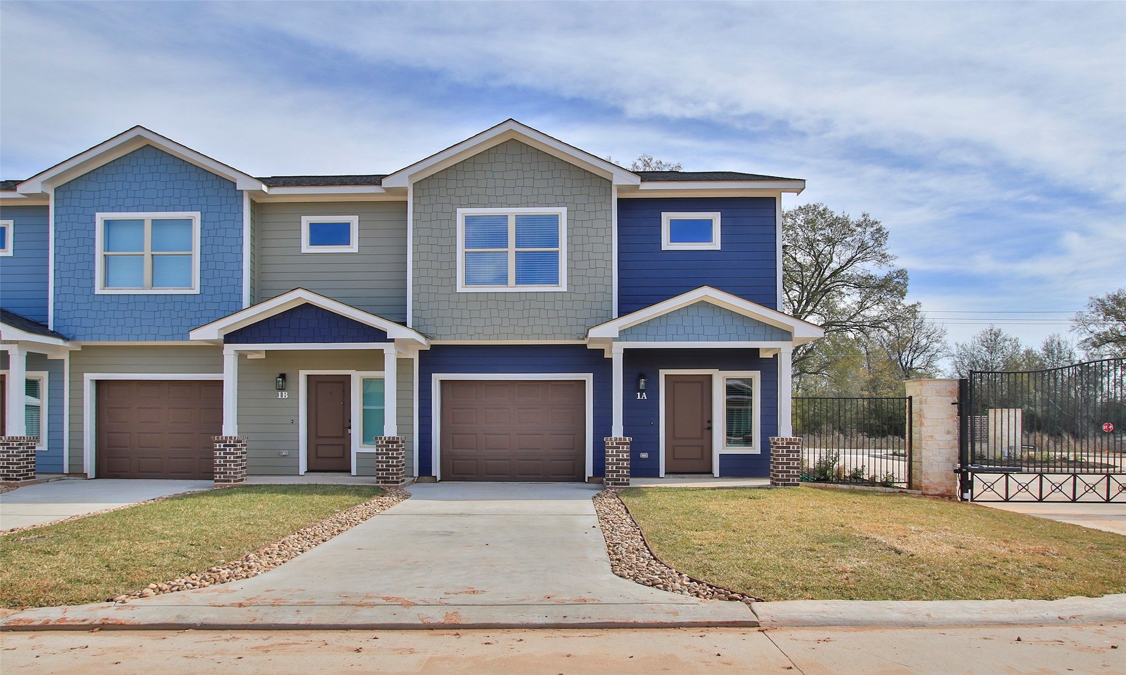 14010 Longstreet Road, Unit 14 Willis, TX 77318 - Photo 2 of 18 a front view of a house with a garden