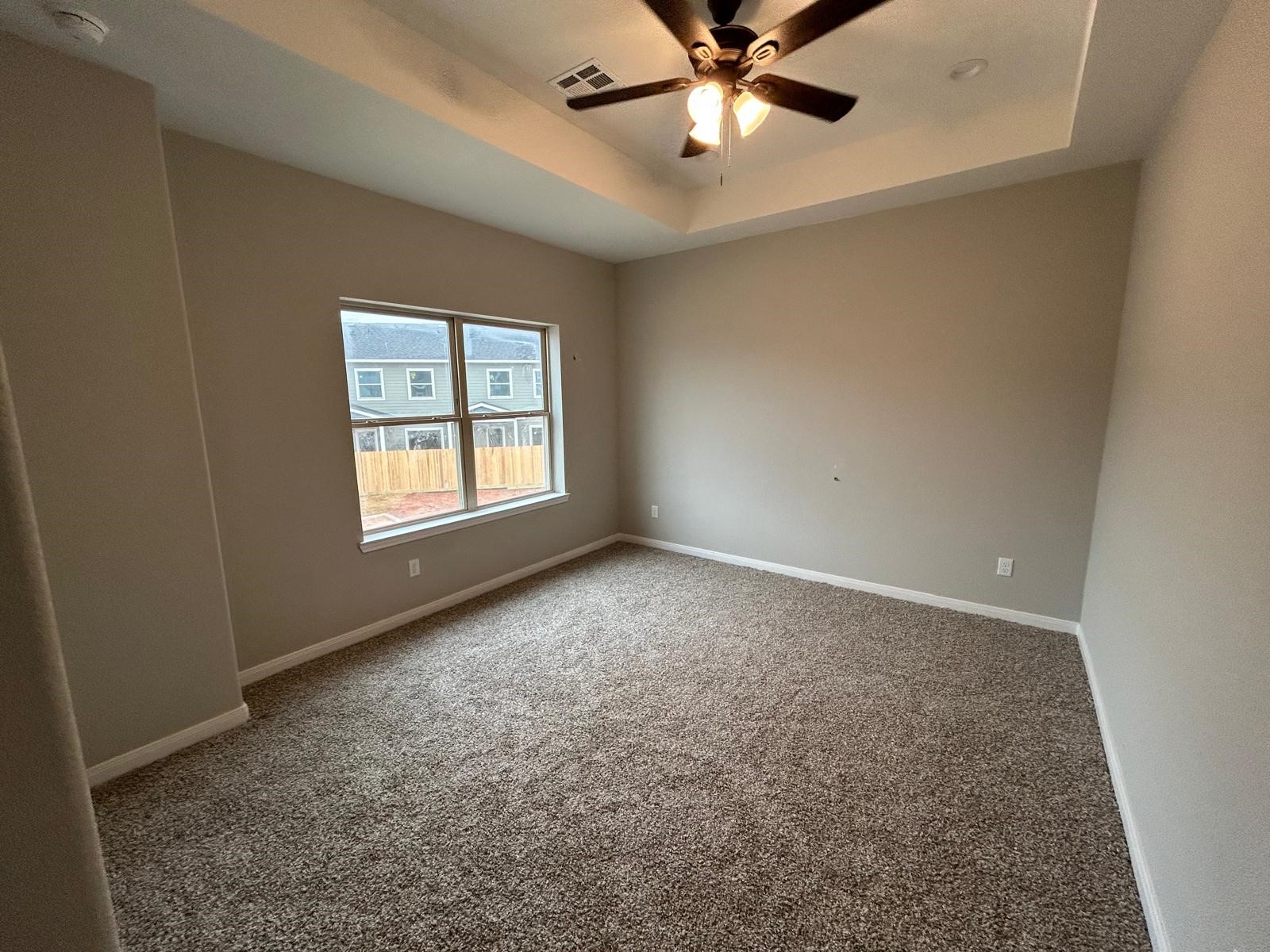 14010 Longstreet Road, Unit 14 Willis, TX 77318 - Photo 9 of 18 an empty room with a window and a fan